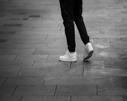 Comfortable shoes stepping on city pavement